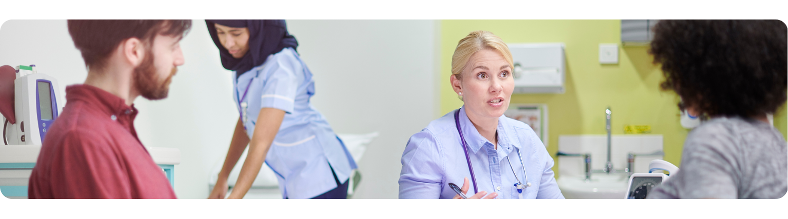 Healthcare professionals and patients in discussion at East Lancashire Hospitals, supporting improved theatre utilisation for elective trauma and orthopaedic care